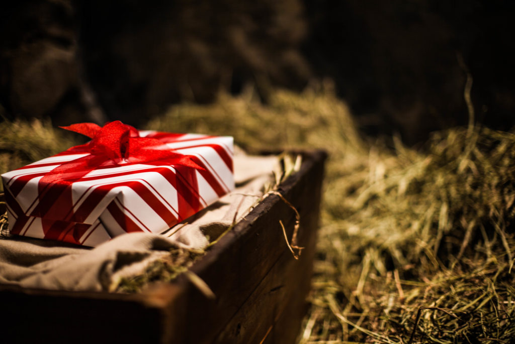 A wrapped gift resting in straw